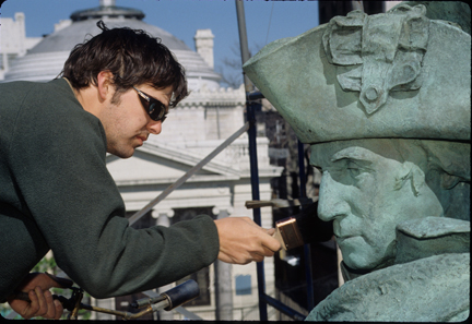 Artist restoring sculpture